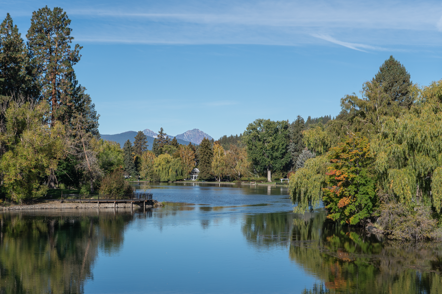 Deschutes River at Mirror Pond in downtown Bend, Oregon with fall color and Cascade Mountain views