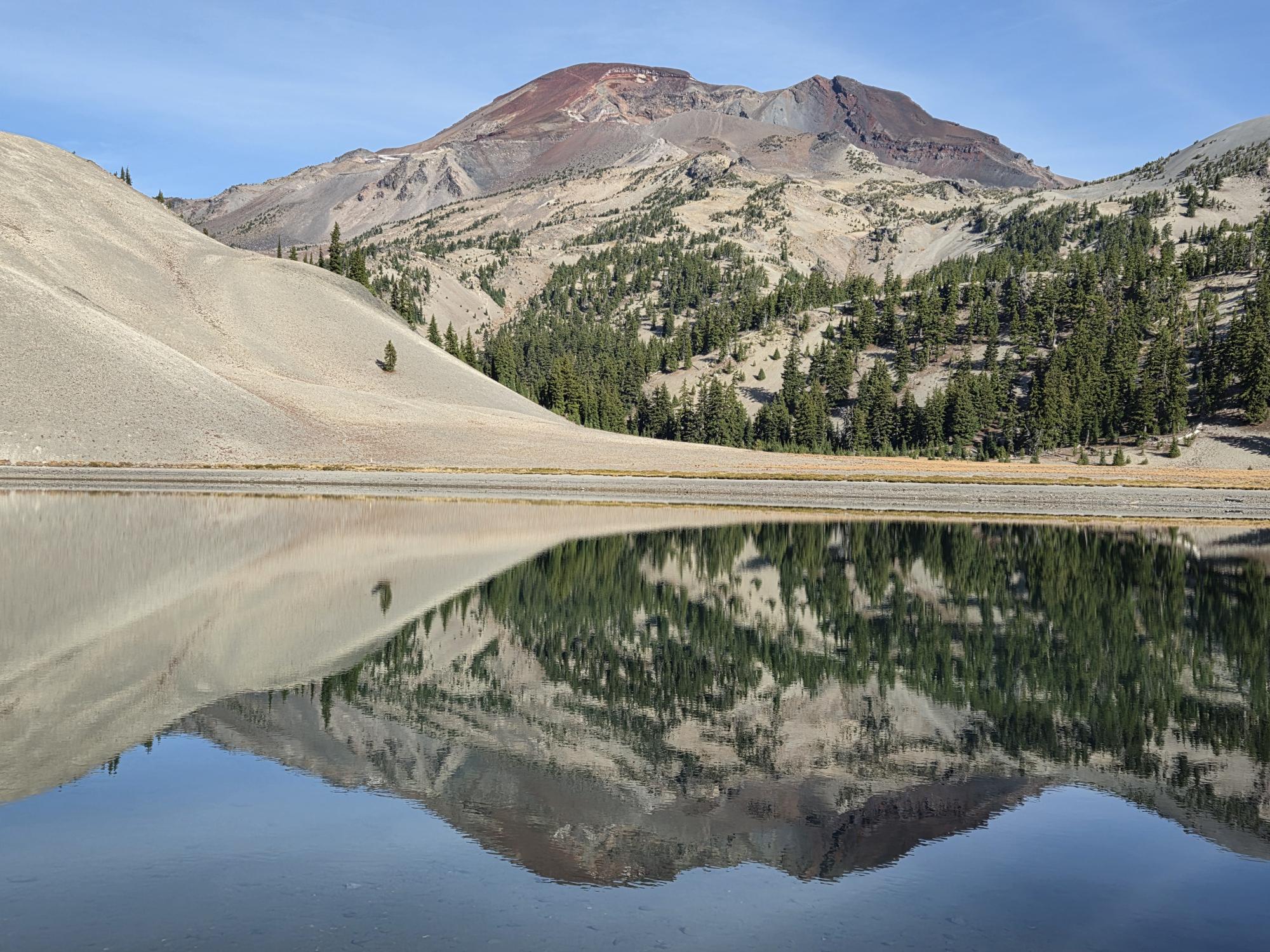 South Sister reflected in the still water of Moraine Lake on a clear October morning.